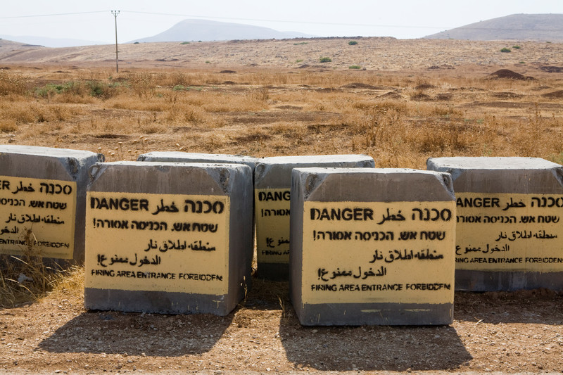 Concrete blocks spraypainted with text warning of live fire military zone