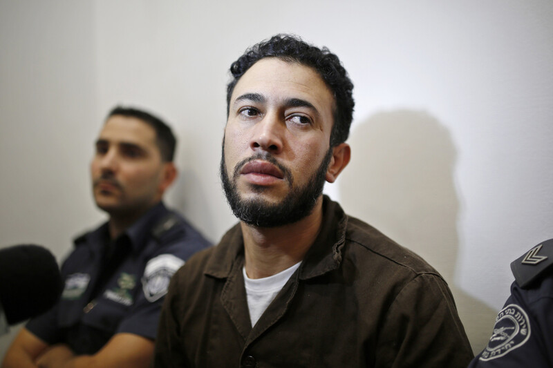 Close-up of young man wearing brown prison uniform