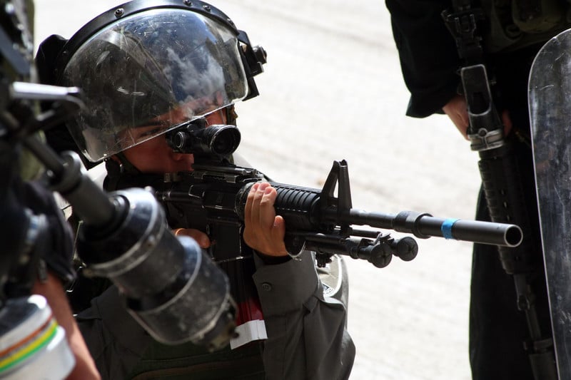 Close-up of Israeli soldier aiming weapon