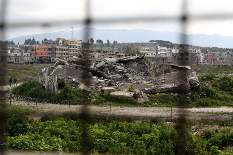 Landscape view of large patch of rubble in middle of refugee camp