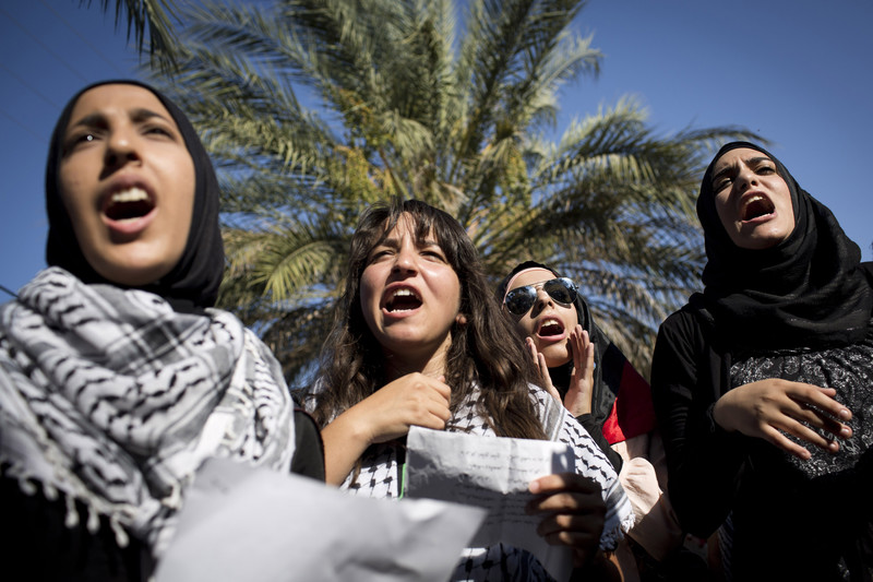 Palestinian women shout during a demonstration