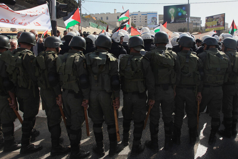 View of the backs of riot police at a demonstration