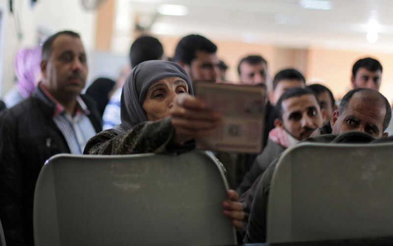 Elderly woman displays travel document in waiting room