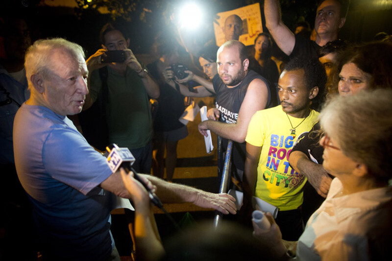 Man speaks to media at night