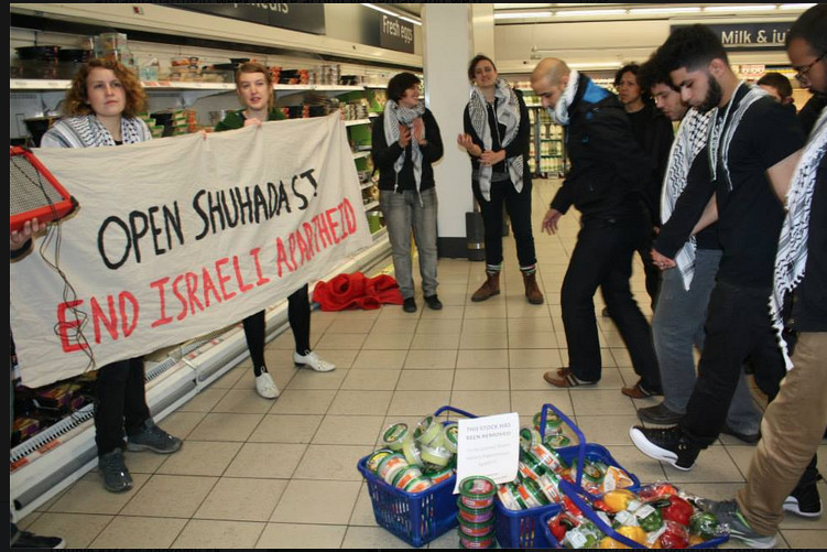 Campaigners take part in a dabke flashmob inside a Sainsbury's supermarket in London to protest it's sale of products supplied by Israeli companies that take part in the colonization of Palestinian land 