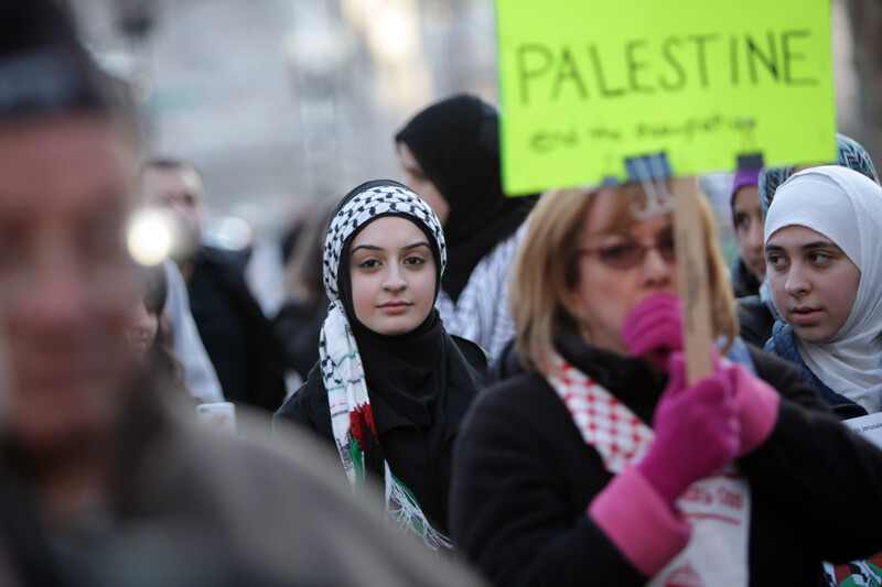 Young woman looks at camera during Palestine solidarity rally