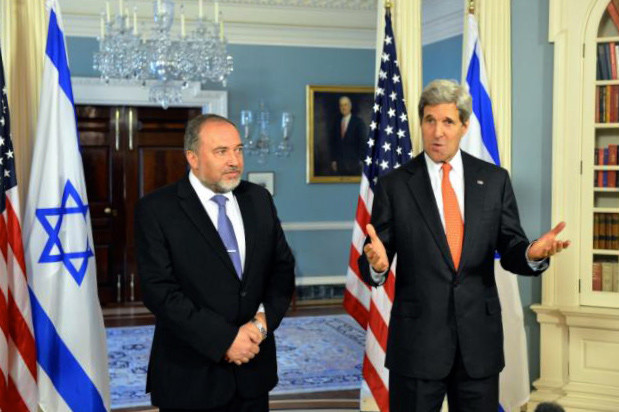 John Kerry gestures with hands while standing next to Avigdor Lieberman