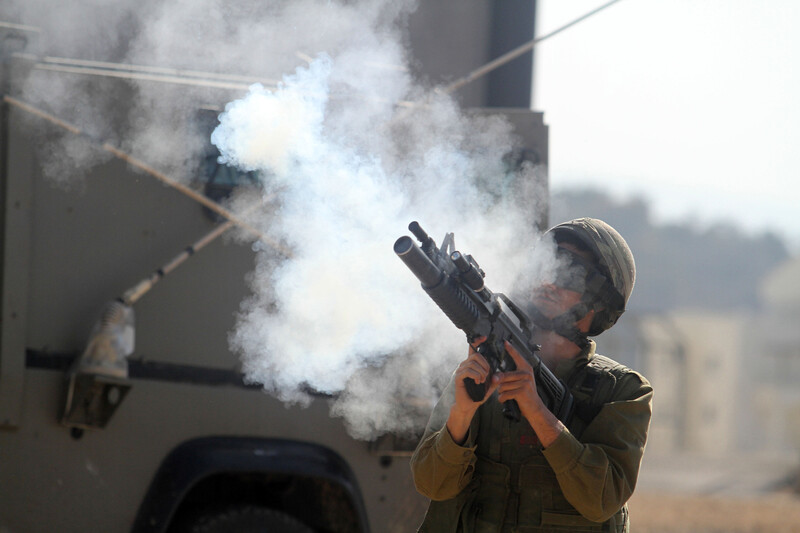 Israeli soldier fires tear gas rifle