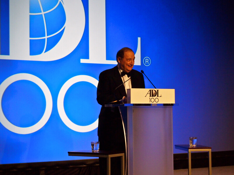 Photo shows Abe Foxman at ADL podium