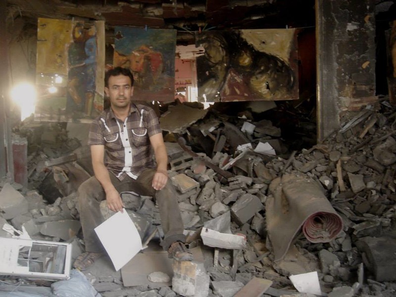 Raed Issa has hung damaged paintings in the ruins of his Gaza home.