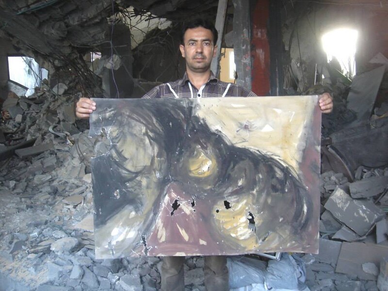 Artist Raed Issa holds up one of his damaged paintings in his bombed-out house in Gaza. (Photos courtesy of Raed Issa)