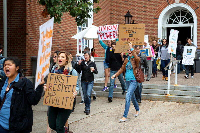 Young people carry signs in support of free speech, academic freedom and reinstatement of Steven Salaita