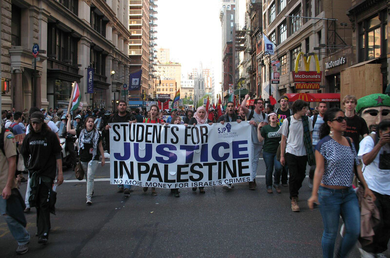 Protesters hold a banner.