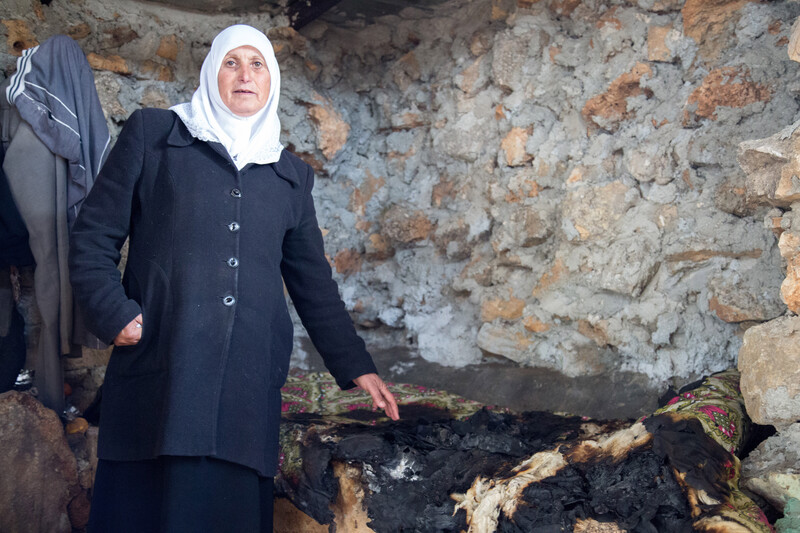 Woman stands in burned-out room