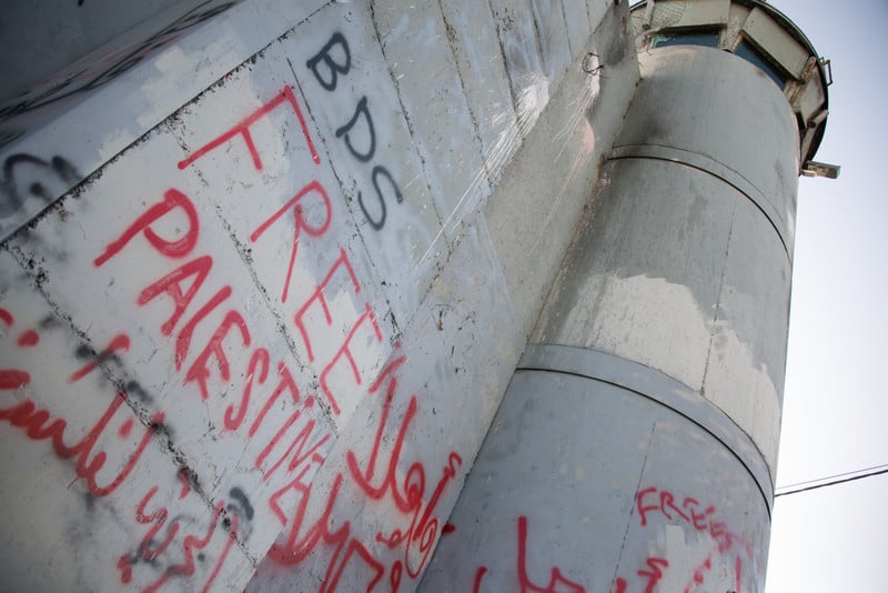 Graffiti reading BDS and Free Palestine is seen on Israel's concrete wall in West Bank