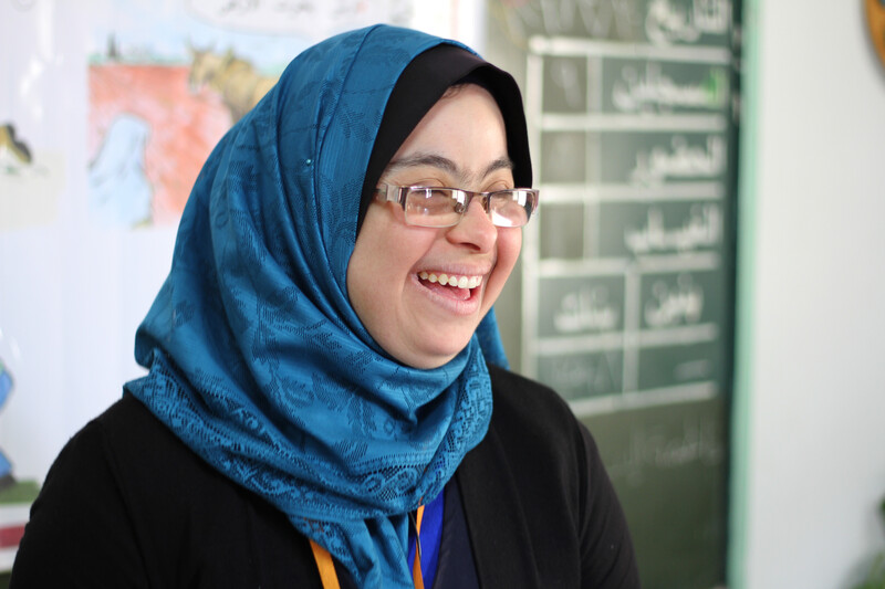 Close-up portrait of woman smiling at front of classroom