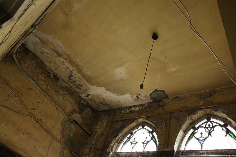 Interior view of historic building with water-damaged ceiling