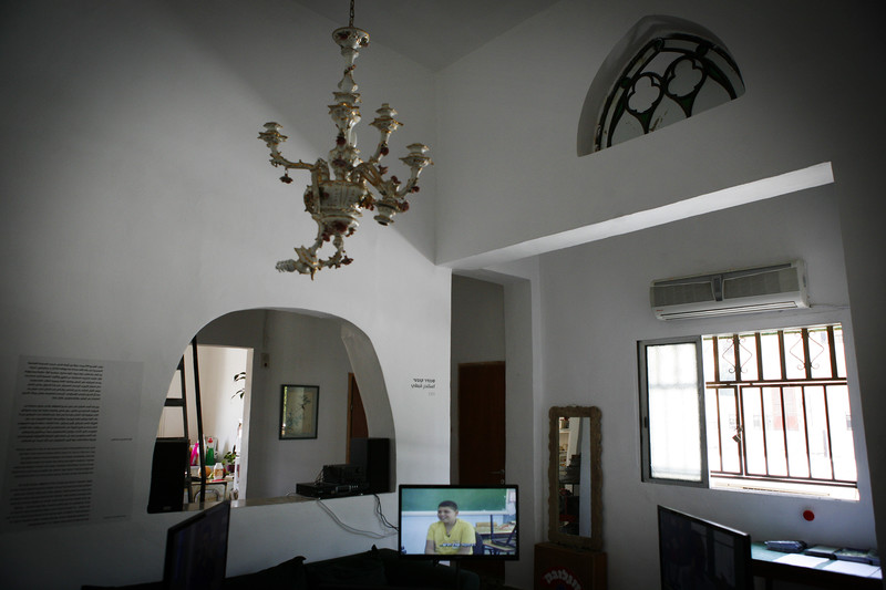 Interior of room with high ceilings, antique candelabra and white walls