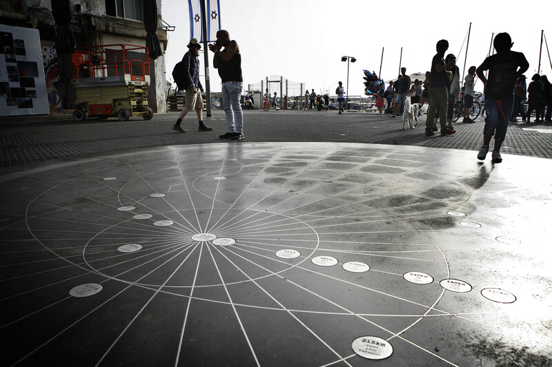 View of installation on ground with people standing around it