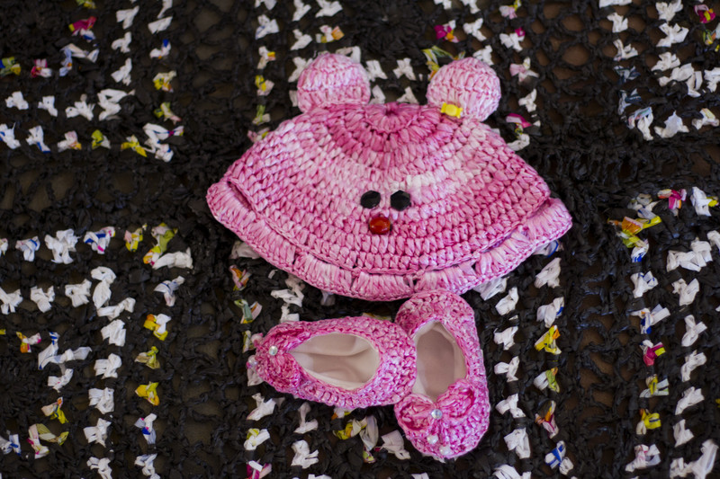 Baby's hat and booties crocheted out of plastic bags