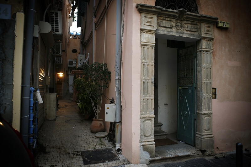 An ornate doorway is embedded into plaster walls