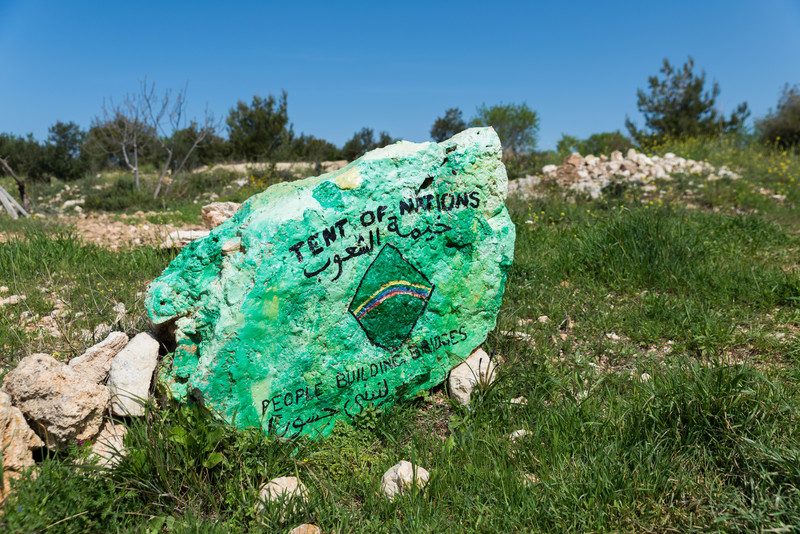 A painted rock reads Tent of Nations