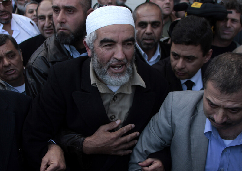 Raed Salah walks through crowd of men