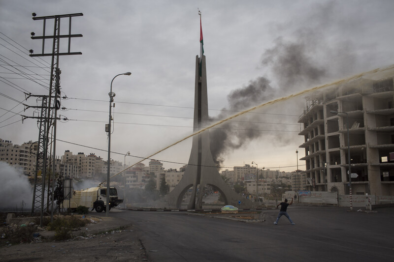 Israeli military vehicle shots skunk spray high above protester