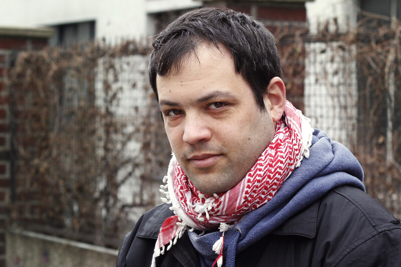 Portrait of young man wearing checkered traditional Palestinian scarf