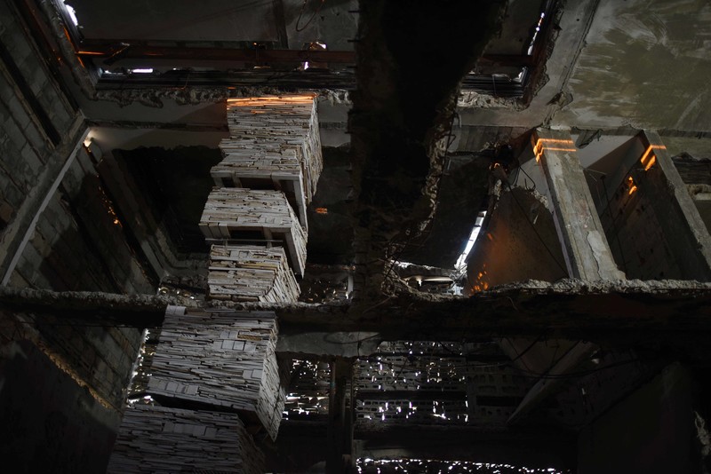 Interior view of installation shows pillars and walls made out of stacked debris