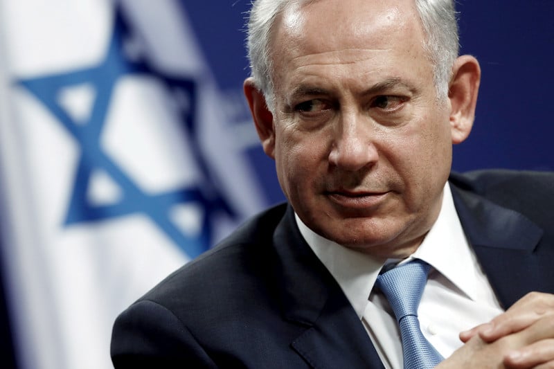 Close-up of Netanyahu with Israeli flag behind him