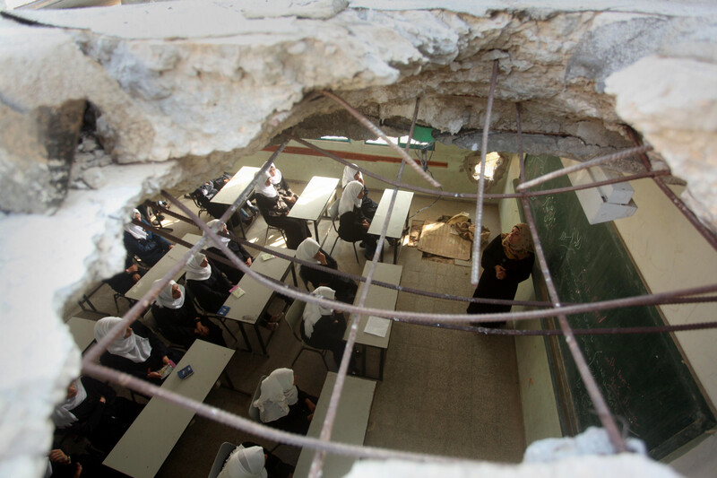 Aerial view of a classroom with a hole in the roof and in one of the walls