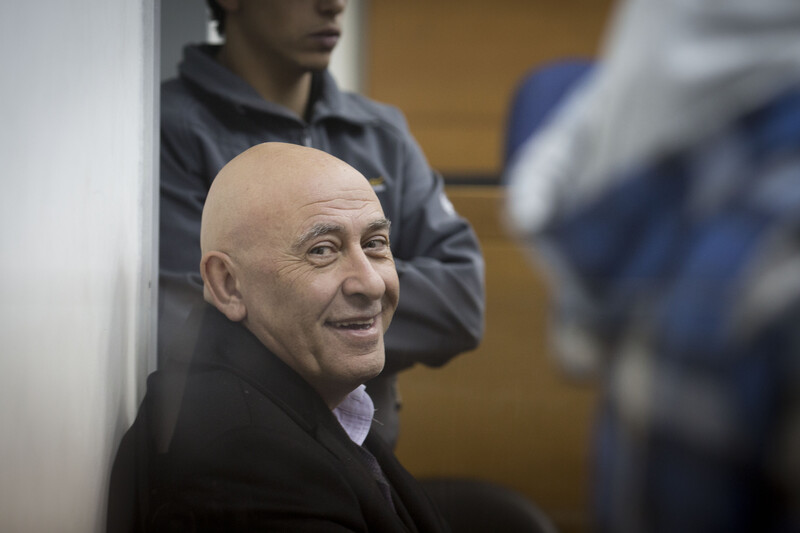 Basel Ghattas smiles at camera while sitting down in courtroom