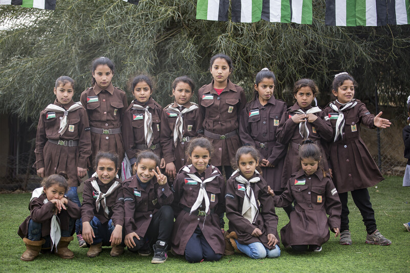 Palestinian schoolchildren in uniform pose for a picture.