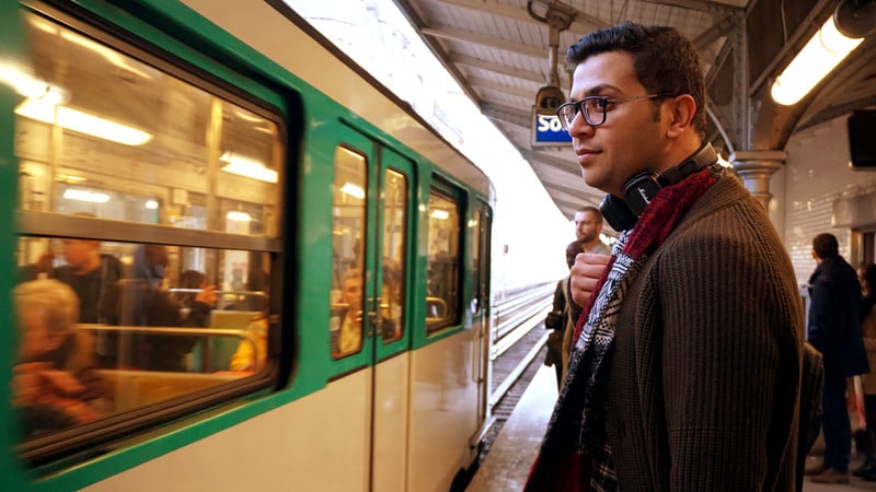Portrait of young man standing at a train platform