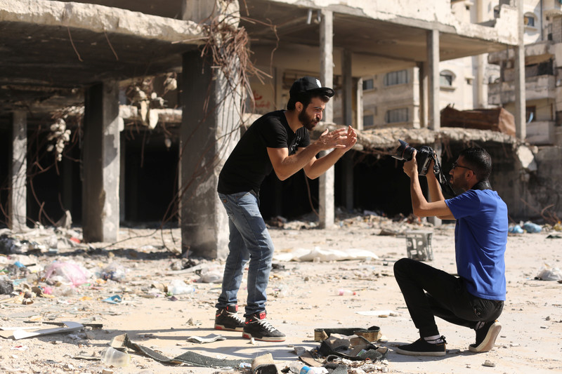 Omar Elemawi films Palestinian rapper Ibrahim Ghunaim (MC Gaza) in front of destroyed buildings in Gaza City