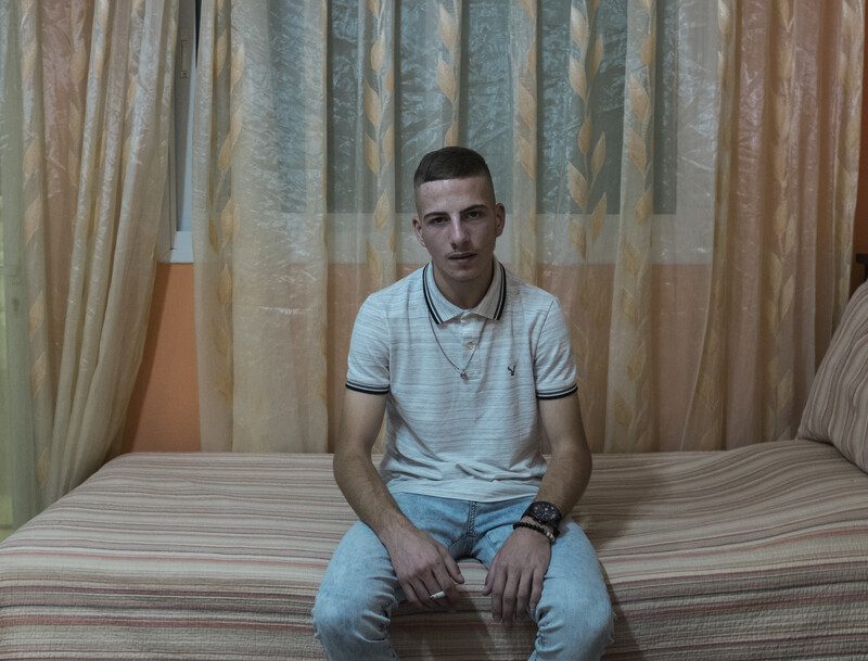 Ali Aleyeh sits on his bed. 