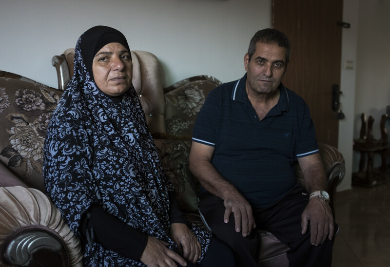 Fatma (left) and Jamal Elayan sit for a portrait in their temporary home