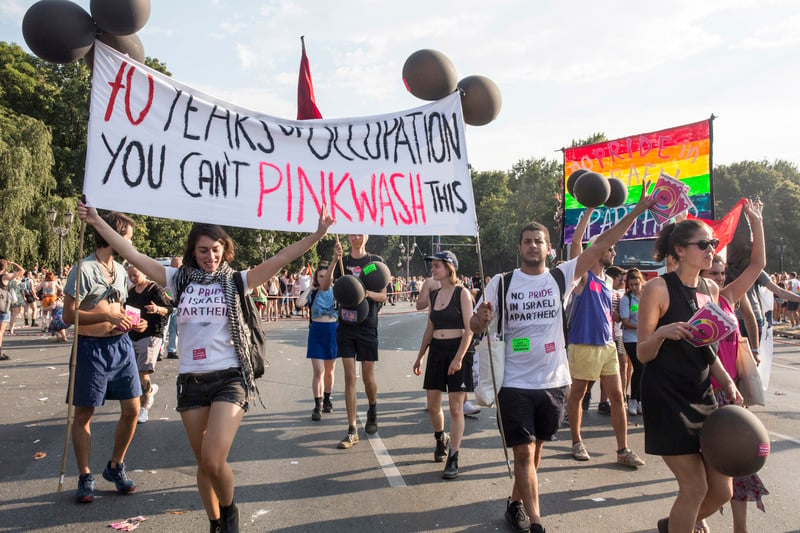 Activists hold a banner declaring '70 years of occupation. You can't pinkwahs this" at a Berlin, Germany protest in 2018