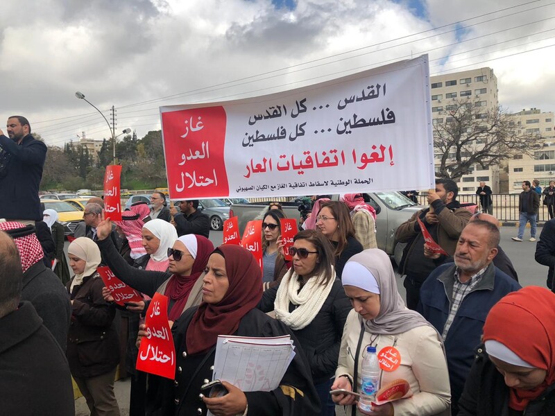 Protesters hold up banners on the street. 