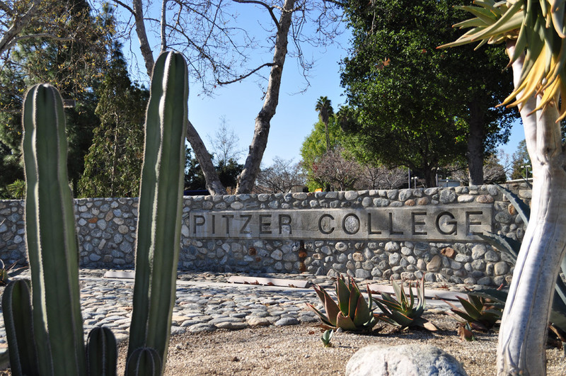 A rock wall displays the name of Pitzer College
