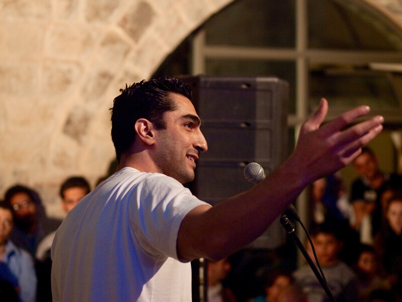 A man speaks at a microphone