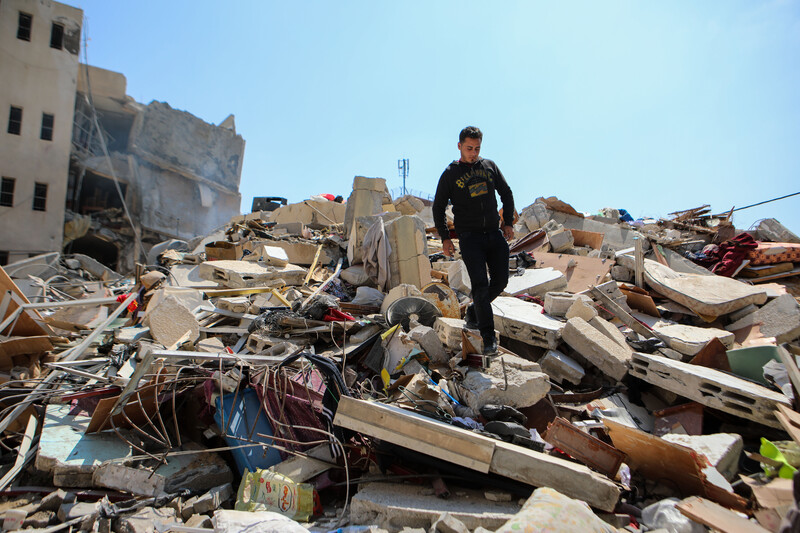 Walid al-Shawa walks on top of the rubble of eight apartment units leveled by the Israeli military on 25 March 2019. Man stands atop rubble