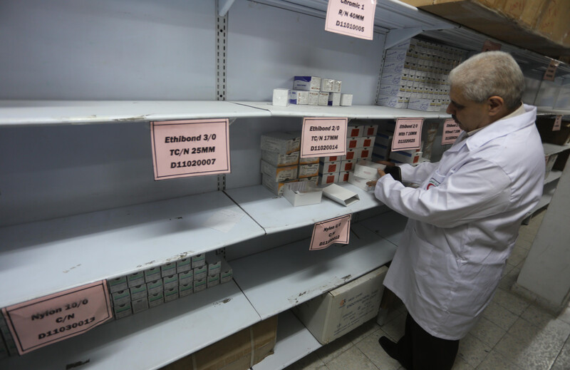 Man stands in front of empty shelving