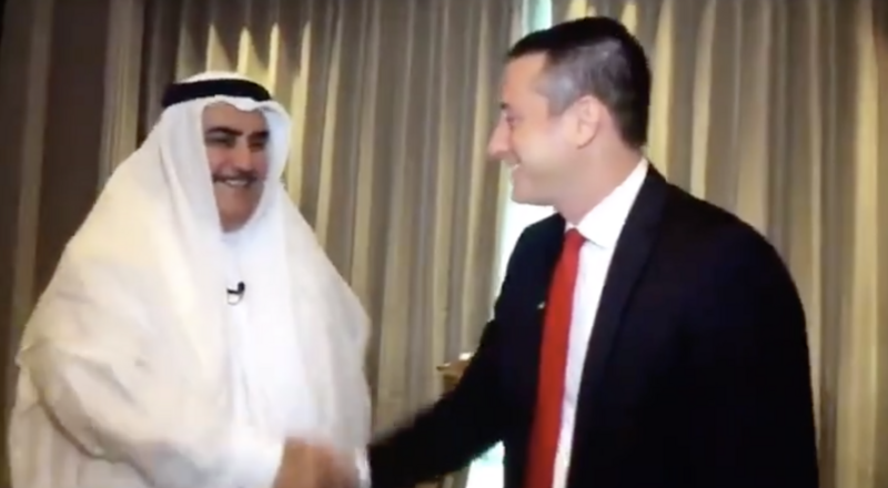 Two men shake hands