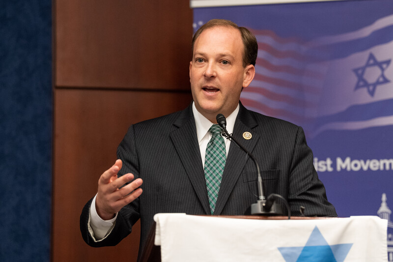 A man stands at a podium gesturing