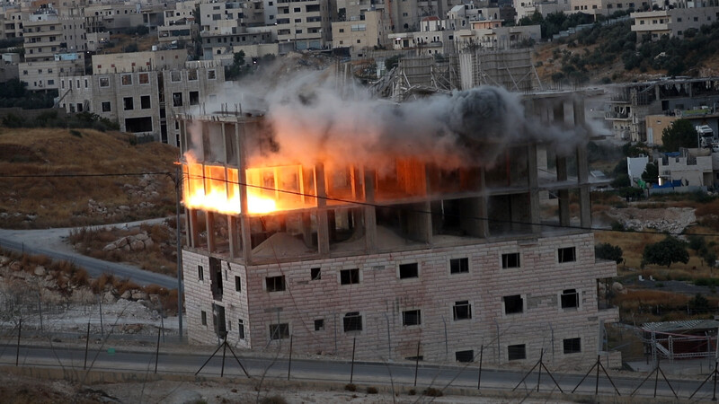 Fire coming out of floor under construction in multi-story bulding