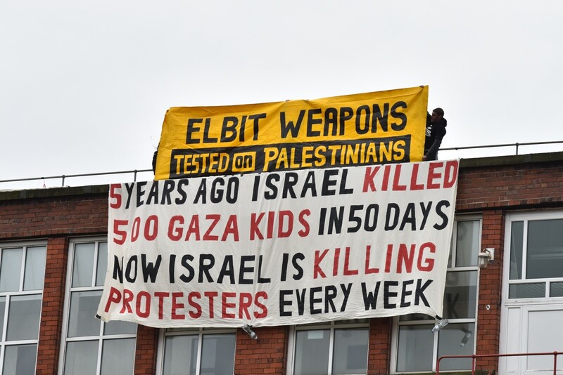 Banners hang from the roof of a building.