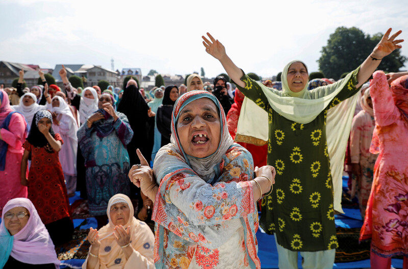 Close up of a woman gesticulating with other women behind her