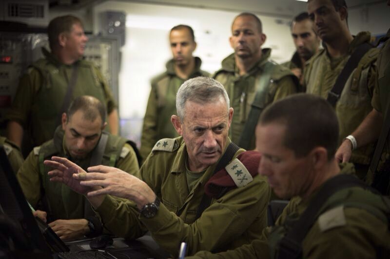 Men in military uniforms confer